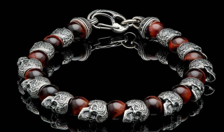 William Henry Motivation Skull Bracelet.This Piece Is Built On Aircraft Grade Stainless Steel Cable Featuring Red Tiger Eye Beads Offsetting The Sculpted Sterling Skulls Arount The Wrist